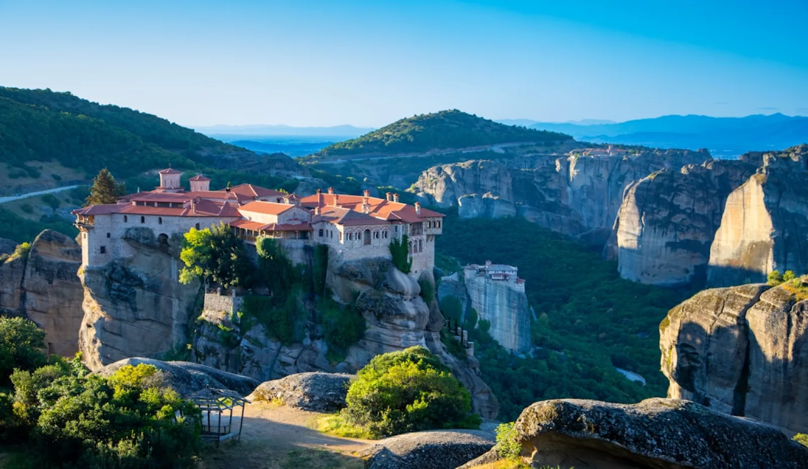 a castle perched on top of a cliff surrounded by mountains