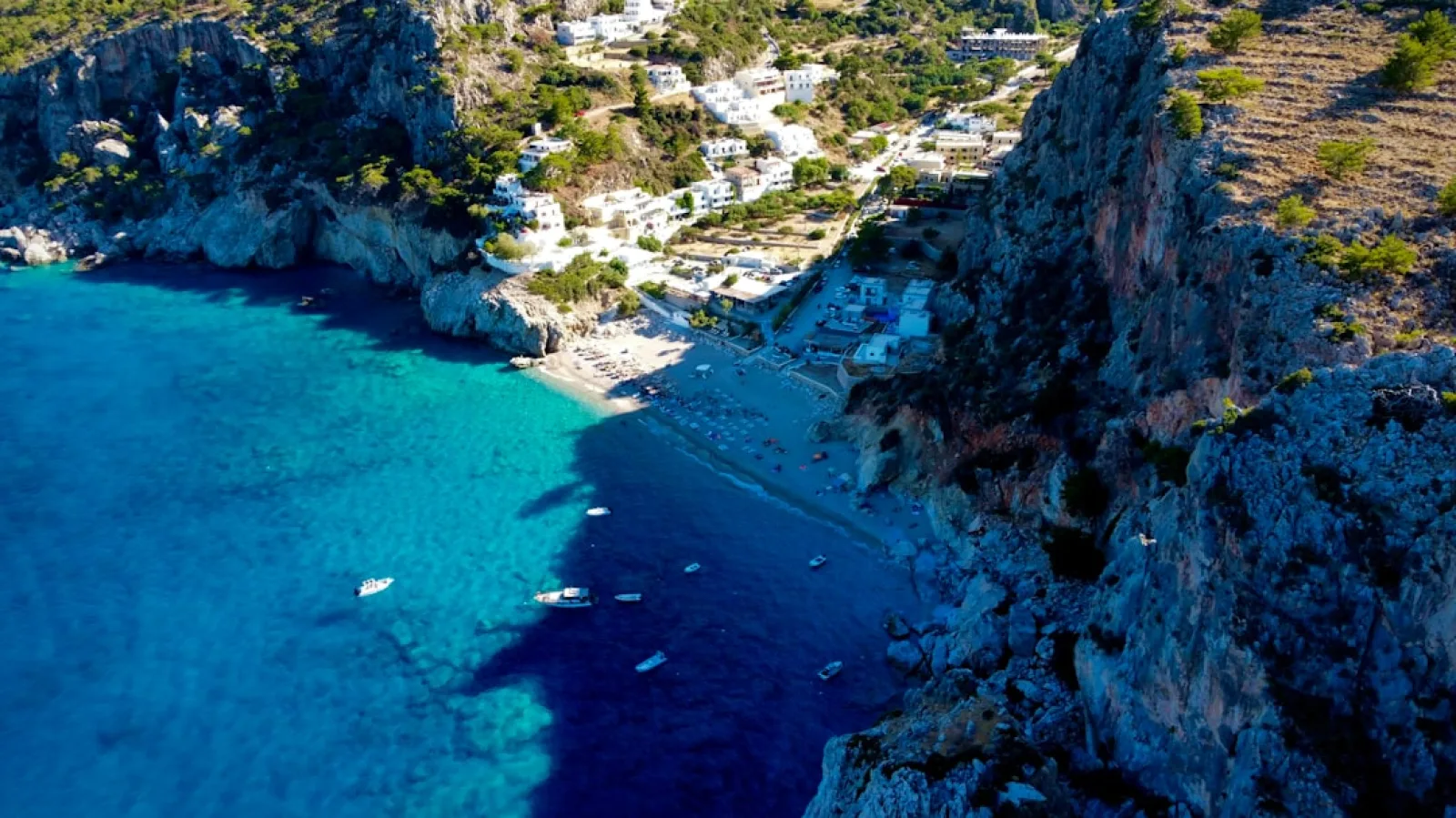 a rocky beach with boats