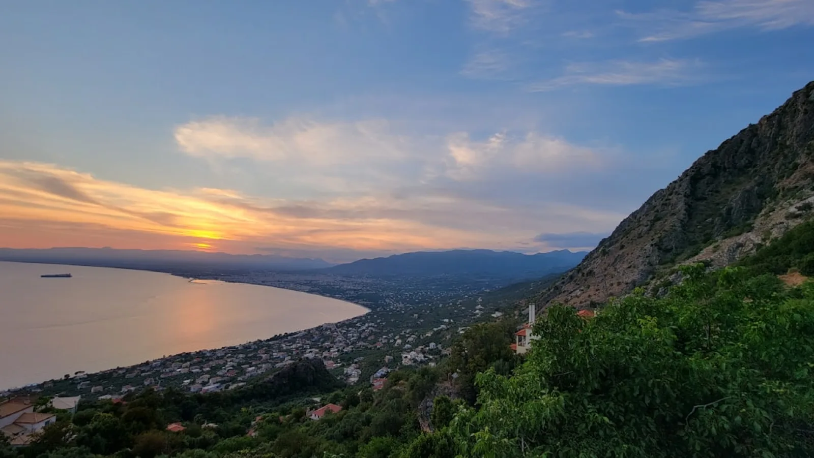 a scenic view of a lake and mountains at sunset