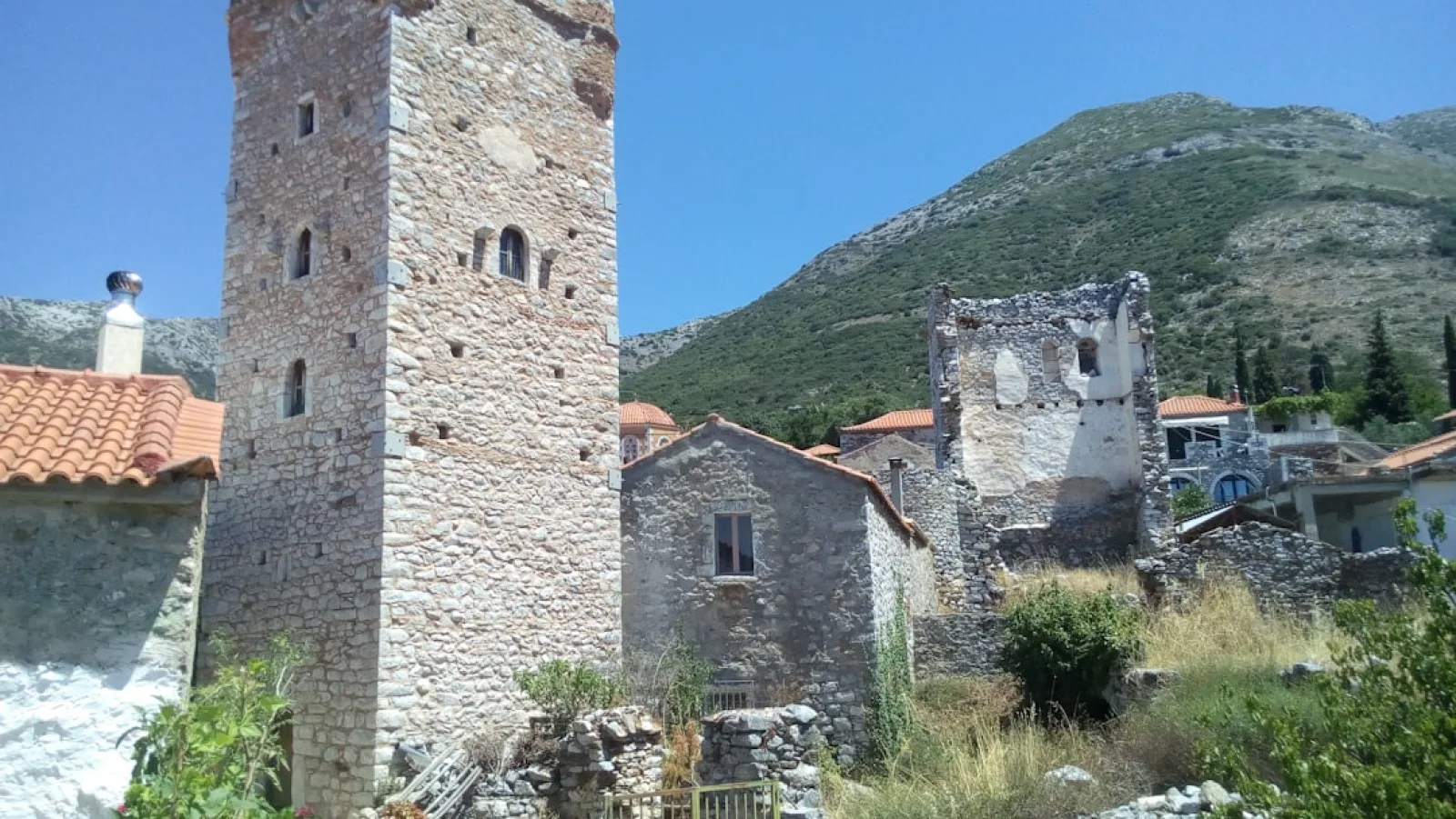 a stone building with a hill in the background