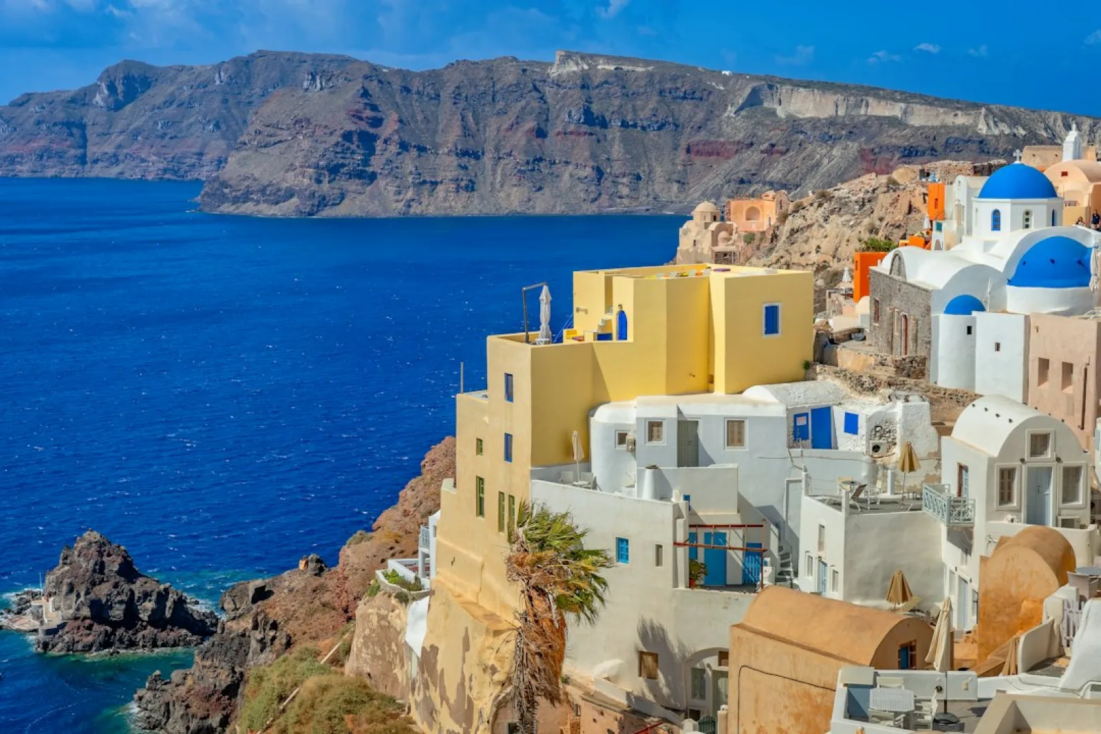 Santorini village with blue-domed buildings overlooking the aegean sea