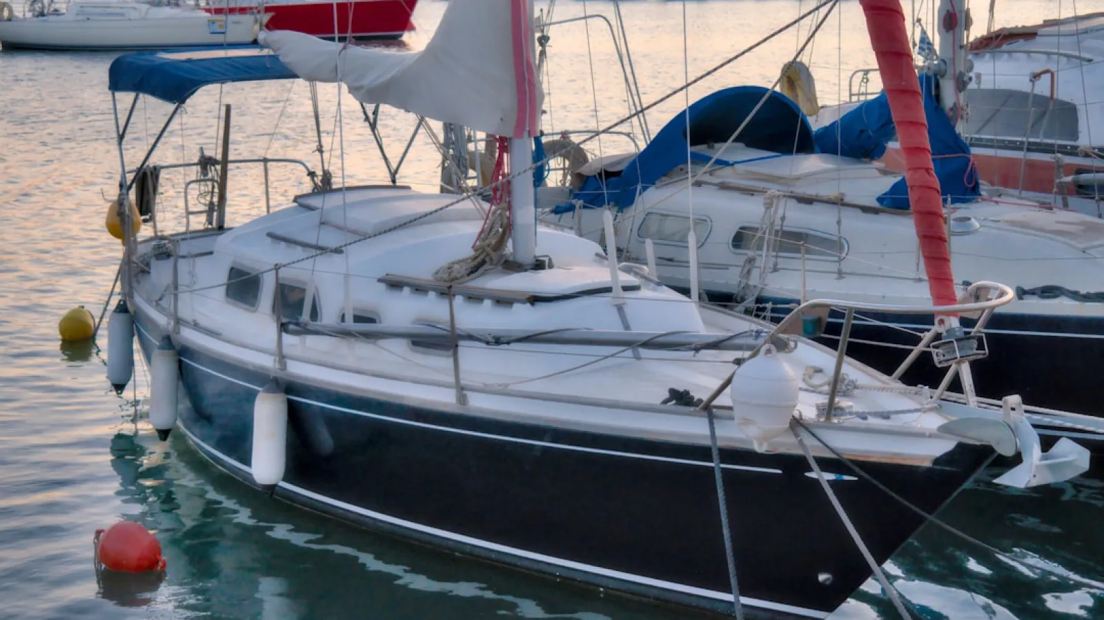 white and blue sailboat on sea during daytime